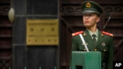 A Chinese paramilitary policeman stands guard outside of the North Korean Embassy in Beijing, April 20, 2017. 