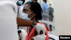 Seorang perempuan menerima vaksin COVID-19 produksi AstraZeneca/Oxford yang didistribusikan melalui program COVAX di Nairobi, Kenya (foto: dok). 
