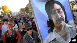 FILE - Marchers carry a large painting of jailed American Indian Leonard Peltier during a march for the National Day of Mourning in Plymouth, Mass, Nov. 22, 2001. United American Indians of New England held its first National Day of Mourning in 1970.