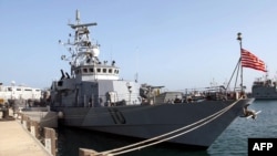 This photo released by the US Navy on March 13, 2003, shows the US Navy patrol boat USS Firebolt moored in port displaying the "Don't Tread On Me" flag, March 10, 2003, at Camp Patriot, Kuwait.