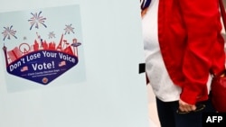 A voter prepares to cast a ballot on an electronic voting machine inside a vote center on Election Day during the Nevada 2024 presidential primary election in Las Vegas, Nevada, on Feb. 6, 2024. 