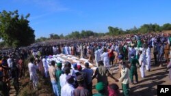 People attend a funeral for those killed by suspected Boko Haram militants in Zaabarmar, Nigeria, Nov. 29, 2020. 