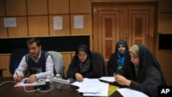 Iranian journalists wait for the announcement of results of parliamentary and Experts Assembly elections at the Interior Ministry, in Tehran, Iran, Feb. 27, 2016. 