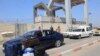 Palestinians with foreign passports arrive at the Rafah gate hoping to cross into Egypt as Israel's attacks on the Gaza Strip continues on October 14, 2023.