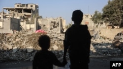 Children look at the destruction following an Israeli strike in the Nuseirat refugee camp in the central Gaza Strip on Nov. 7, 2024.