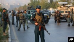 Afghan security forces stand guard after an attack on the American University of Afghanistan in Kabul, Afghanistan, Aug. 25, 2016.