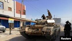 Troops from eastern Libyan forces are seen in Ain Zara, south of Tripoli, Libya, April 11, 2019. 
