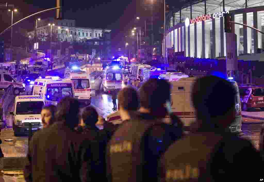 Police officers and ambulances fill the street next to the Besiktas football club stadium, Dec. 10, 2016.