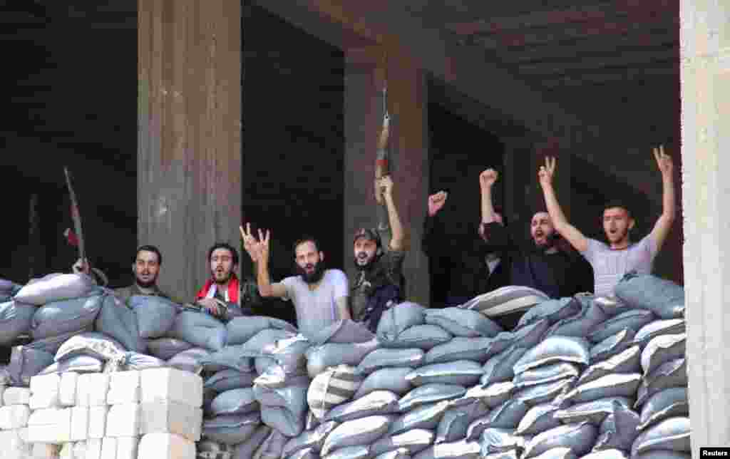 Soldiers loyal to President Bashar al-Assad pose for a photo in Aleppo's main prison, May 22, 2014.