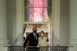 President Joe Biden and first lady Jill Biden watch fireworks from the White House, Wednesday, Jan. 20, 2021, in Washington. (AP Photo/Evan Vucci)