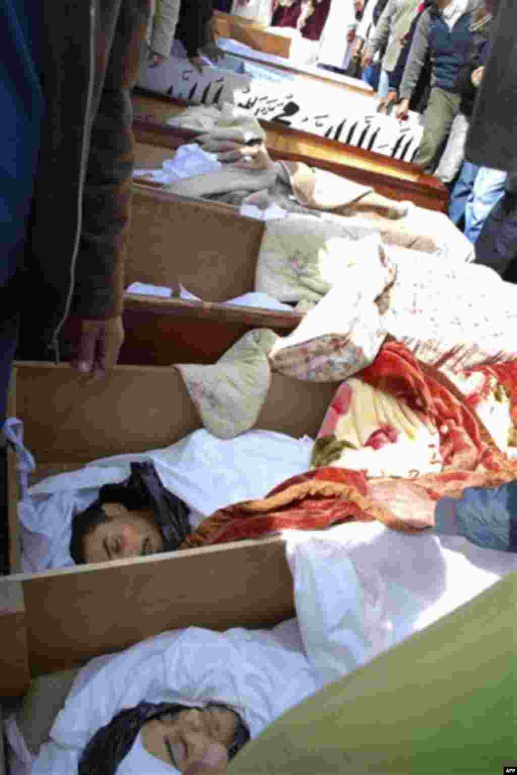 ** EDS NOTE GRAPHIC CONTENT ** This photograph, obtained by The Associated Press outside Libya and taken by an individual not employed by AP, shows dead bodies in coffins during recent days' unrest in Benghazi, Libya. (AP Photo) EDITOR'S NOTE: THE AP HAS
