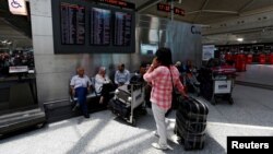 Passengers wait for their flights at Turkey's largest airport, Istanbul Ataturk, following yesterday's blast, June 29, 2016. 