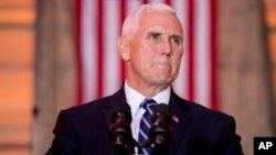 FILE - Vice President Mike Pence pauses while speaking to troops at Al Asad Air Base, Iraq, Nov. 23, 2019. 