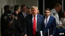 (FILES) Former US President Donald Trump, with his lawyer Todd Blanche, walks to speak to the press at the end of the day of his trial for allegedly covering up hush money payments linked to extramarital affairs at Manhattan Criminal Court in New York Ci