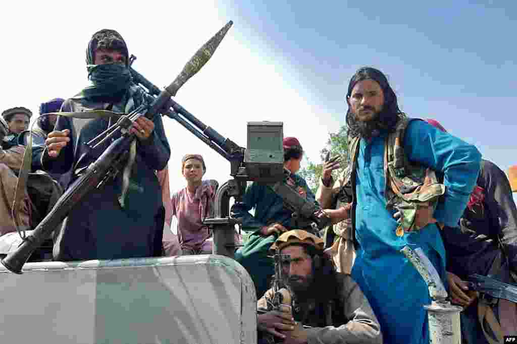 Combatientes talibanes se sientan junto a un vehículo en una calle de la provincia de Laghman el 15 de agosto de 2021.