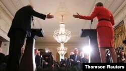 FILE - Britain's ambassador to the U.S. Kim Darroch listens as U.S. President Donald Trump and British Prime Minister Theresa May hold a joint news conference at the White House in Washington.