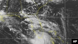 This Saturday, Sept. 12, 2020 image provided by NOAA shows the formation of Tropical Storm Sally. The storm is expected to reach hurricane strength, Sept. 14, 2020 as it approaches the U.S. Gulf Coast.