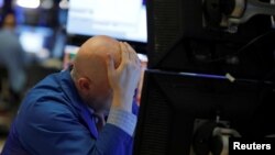 A trader works on the floor of the New York Stock Exchange (NYSE) in New York City, New York, U.S., March 11, 2020. 