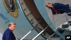 President Donald Trump boards Air Force One at Palm Beach International Airport, in West Palm Beach, Fla., Dec. 31, 2020.