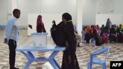 FILE - A woman casts her vote during Somalia's parliament election, at a polling station in Mogadishu, Somalia, Dec. 6, 2016.