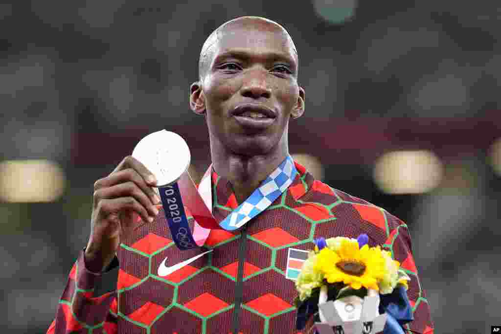 Silver medalist Timothy Cheruiyot, of Kenya, poses on the podium during he medal ceremony for the men's 1,500-meters at the 2020 Summer Olympics, Saturday, Aug. 7, 2021, in Tokyo. (AP Photo/Martin Meissner)