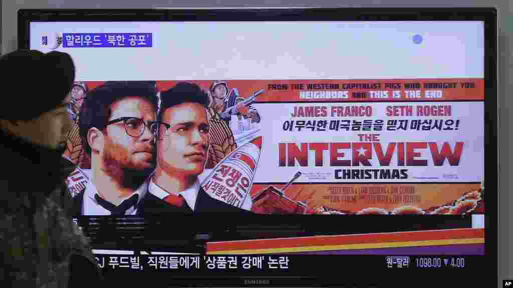 Un soldat de l'armée sud-coréenne marche près d'un écran de télévision montrant une annonce de Sony Picture "The Interview", à la gare de Séoul à Séoul, Corée du Sud, le 22 décembre 2014.