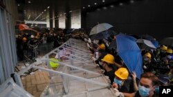 Protesters are seen as they forcefully enter the Legislative Council in Hong Kong, July 1, 2019.