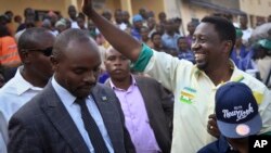 Presidential candidate Frank Habineza (center-right), of the opposition Democratic Green Party greets supporters at an election campaign rally in Musanze District, Rwanda, July 28, 2017.