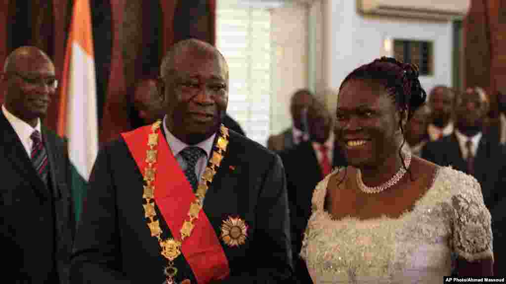 En compagnie de son épouse Simone, Laurent Gbagbo, président sortant ivoirien, contestant les résultats officiels de la Commission électorale qui donnent son rival Alassane Ouattarra vainqueur, reçoit les hommages des fonctionnaires et de ses partisans lors d'une prestation de serment parallèle, au Palais présidentiel d'Abidjan, 4 décembre 2010.