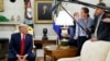 FILE - President Donald Trump talks to reporters in the Oval Office of the White House, in Washington, July 9, 2019.