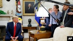FILE - President Donald Trump talks to reporters in the Oval Office of the White House, in Washington, July 9, 2019.