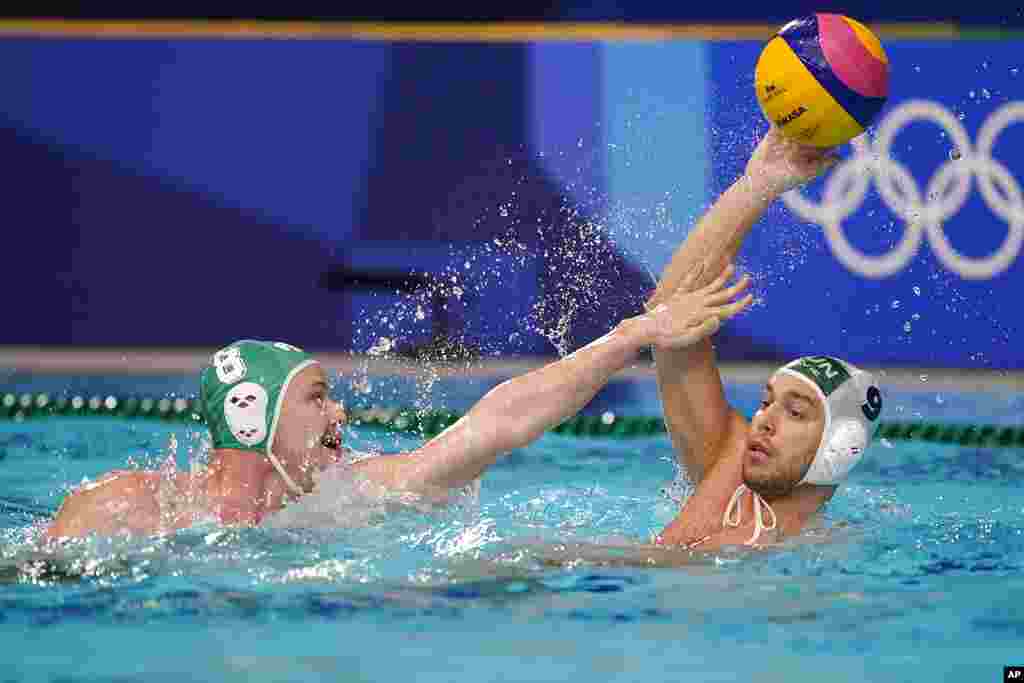 South Africa's Nicholas Rodda (8) defends against Hungary's Balazs Erdelyi (9) during a preliminary round men's water polo match at the 2020 Summer Olympics, Thursday, July 29, 2021, in Tokyo, Japan. (AP Photo/Mark Humphrey)