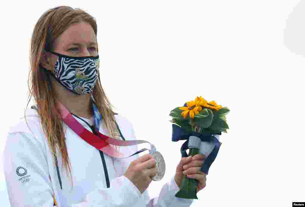 Silver medallist, Bianca Buitendag of South Africa wearing a protective face mask poses on the podium after winning the medal in women's shortboard. REUTERS/Lisi Niesner