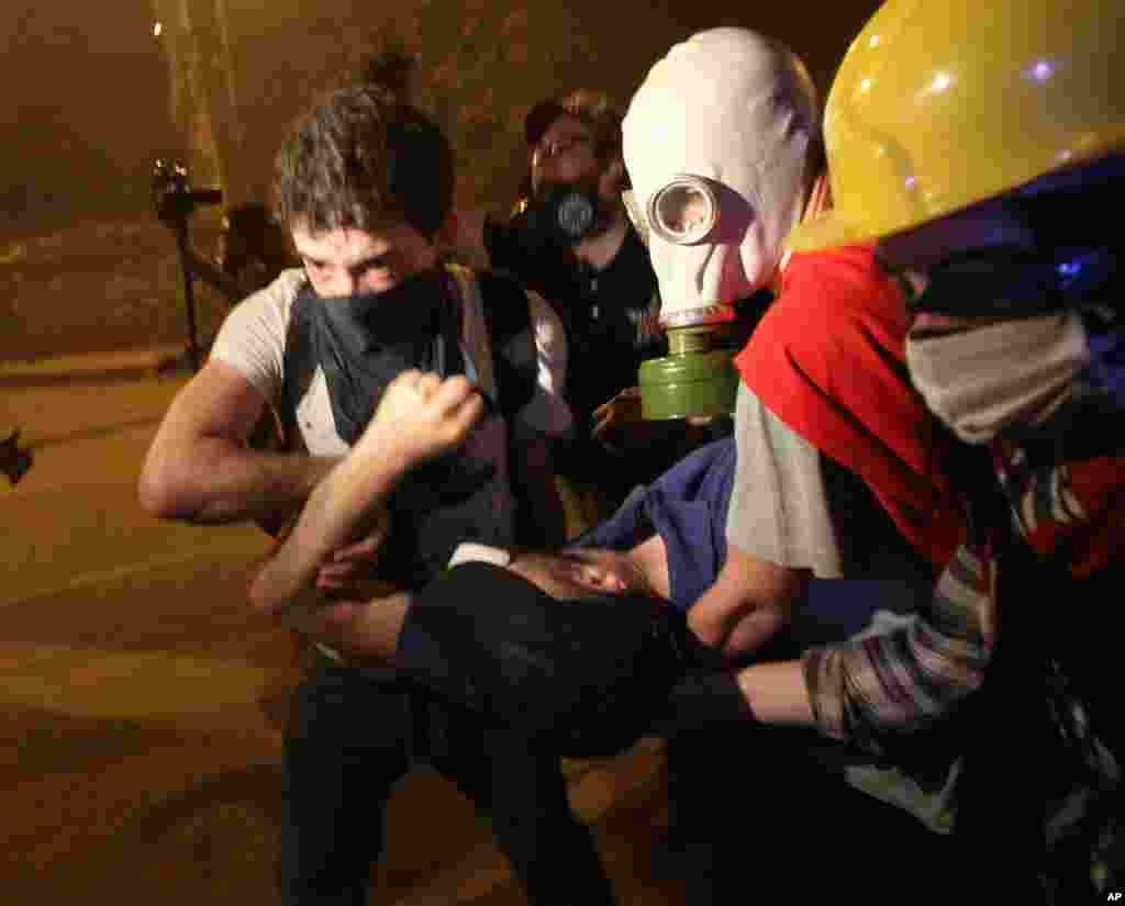 Youths carry an injured demonstrator during nationwide anti-government protests in Besiktas, Istanbul, June 2, 2013.