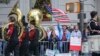 Viewers at the Columbus Day Parade wave a U.S. flag with Italian national colors and signs of expression, Oct. 14, 2019, in New York. 