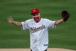 Dr. Anthony Fauci reacts after throwing out the ceremonial first pitch before the start of a Yankees-Nationals game in Washington, July 23, 2020.
