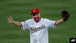 Dr. Anthony Fauci, Director of the National Institute of Allergy and Infectious Diseases, reacts after throwing out the ceremonial first pitch before the start an opening day game between the N.Y. Yankees and the host Washington Nationals, July 23, 2020.