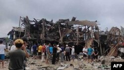 This photo taken and obtained from the Facebook account of Mai So Jar on Sept. 6, 2024 shows people gathering around a destroyed building following an air strike in Namhkham township in Myanmar's northern Shan state. (Photo Courtesy of Facebook user Mai So Jar / AFP) 