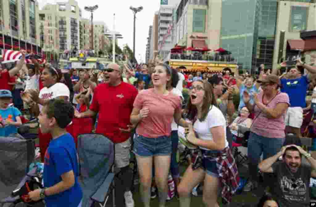 Fans celebrate after the United States scored their third goal against Japan during the first half of the FIFA Women's World Cup soccer championship, National Harbor, Maryland, July 5, 2015.