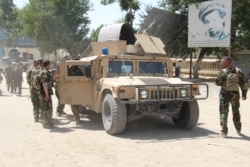 FILE - Afghan commando forces are seen at the site of a battlefield where they clashed with Taliban insurgents in Kunduz province, Afghanistan, June 22, 2021.