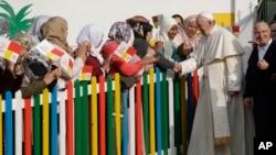 El papa Francisco saluda a mujeres que acudieron a recibirlo en el Centro Rural para Servicios Sociales en Temara, en el sur de Rabat, Marruecos, el domingo 31 de marzo de 2019.