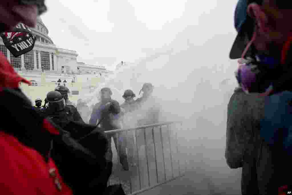 Trump supporters try to break through a police barrier, Jan. 6, 2021, at the Capitol in Washington.