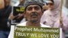 A Muslim protester holds up a sign during a protest against an anti-Islam film made in the U.S. mocking the Prophet Mohammad, outside the U.S embassy in Jakarta September 21, 2012. REUTERS/Enny Nuraheni (INDONESIA - Tags: CIVIL UNREST RELIGION)