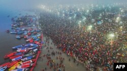 This aerial handout photograph taken and released by India's Uttar Pradesh State Information Department on January 13, 2025 shows Hindu pilgrims taking a holy dip in the sacred waters of Sangam, the confluence of Ganges, Yamuna and mythical Saraswati rive