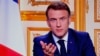 French President Emmanuel Macron is seen on monitors in a control room at AFP headquarters as he addresses the nation during a televised broadcast from the presidential Elysee Palace, on the day of the prime minister's resignation on Dec. 5, 2024.