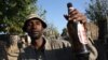 On a Friday evening in Diepsloot, the streets are filled with men drinking. (D. Taylor/VOA)
