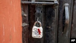 FILE - A sealed lock hangs at the gate of the closed Kashmir Press Club building in Srinagar, Indian-controlled Kashmir, Jan. 18, 2022. 