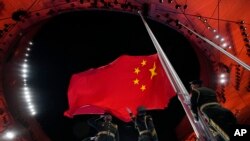 资料照：中国军人在冬运会开幕式上升起中国国旗。（2022年2月4日）