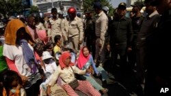FILE - Farmers of Koh Kong province protesting land evictions are blocked by security during a protest rally as it moves near the Prime Minister's residence, in Phnom Penh, Cambodia, Tuesday, Feb. 14, 2017. 