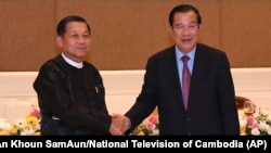 FILE - Cambodian Prime Minister Hun Sen, right, shakes hands with Myanmar State Administration Council Chairman, Senior General Min Aung Hlaing, left, during after a meeting in Naypyitaw, Myanmar, Jan. 7, 2022. 